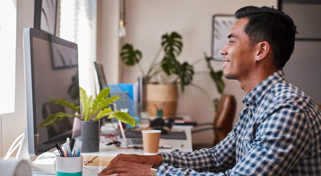 Young profesional sitting in bright office at workstation