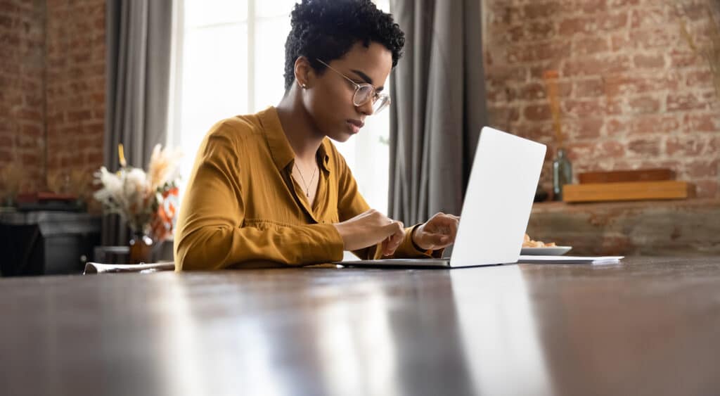 Woman sitting alone focused on laptop