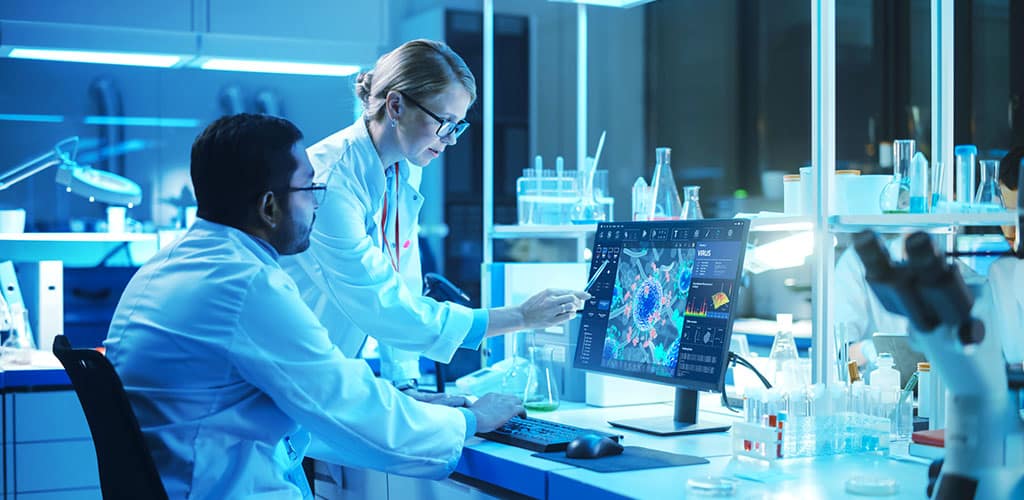 Molecular biologist studying a virus on a computer monitor