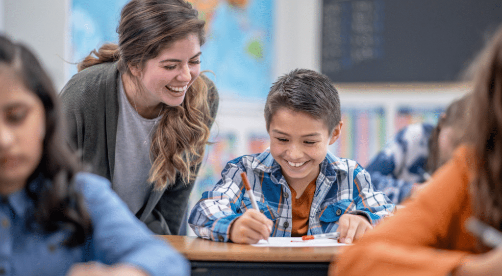 A teacher helping a student in the classroom.